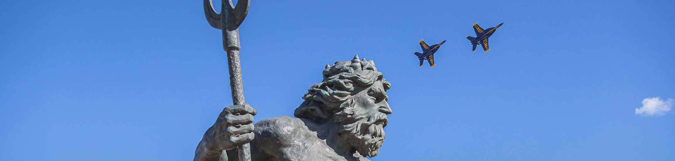 King Neptune with blue angels jets flying overhead.