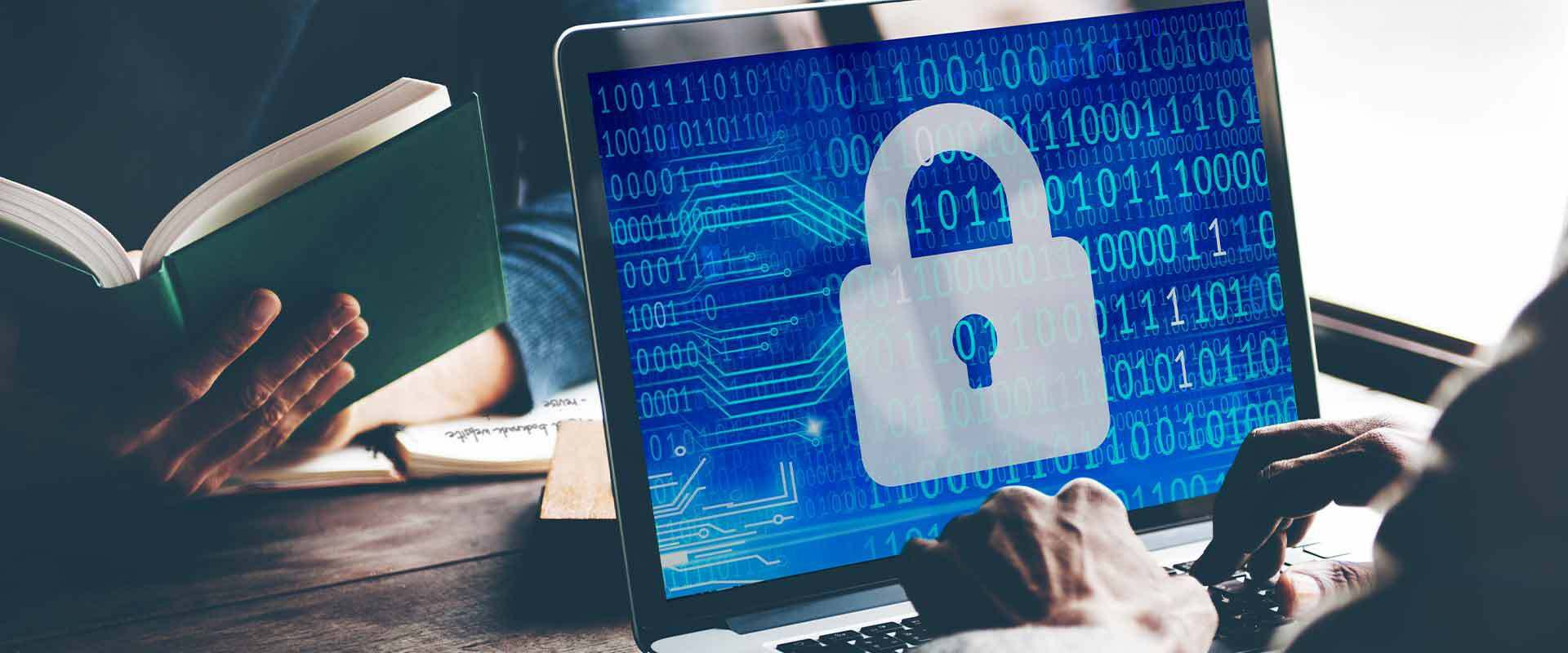 A person working on a laptop with a lock on the screen